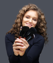 Applying Make-up. Woman with a brush for make-up