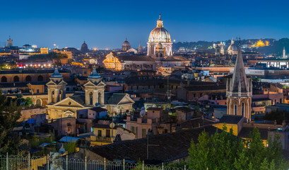 Fototapeta na wymiar Panorama at sunset from the Pincio Terrace with the dome of the Basilica of Ambrogio e Carlo al Corso, in Rome, Italy.