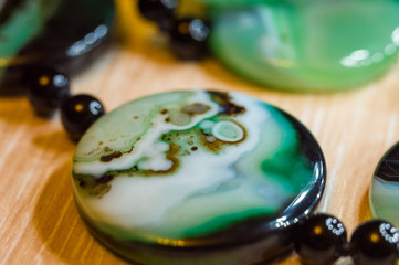Large polished beads of beautiful translucent green agate gemstone, macro