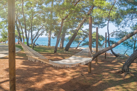 Hammock for camping close-up on the background of the sea and forests on a Sunny day