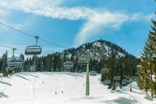 ski chair lift in the Alps against the blue sky, forest and mountains Zugspitz in Germany, Bavaria