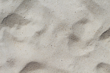 White sand beach texture. Sea coast top view photo. Natural texture. Smooth sand surface with step marks.