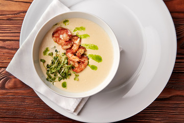 Creamy cheese soup with grilled shrimps