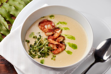 Creamy cheese soup with grilled shrimps