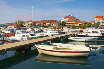 Obraz premium Fishing boats in harbor. Montenegro, view of Tivat city and Marina Kalimanj