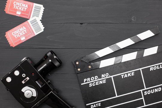 Movie Time, Flat Lay With Space For Text. Cinema Minimal Concept. Cinema Clapperboard, Retro Camera, Movie Tickets On A Black Wooden Background.