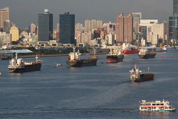 Panoramic river view showing cargo ships and freighters moving into harbour of Kaohsiung city, Taiwan