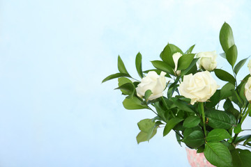 Bouquet of beautiful roses on color background. Space for text