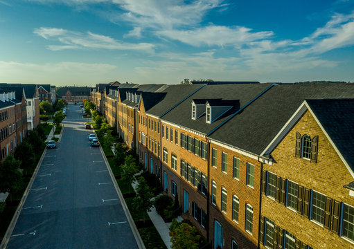 Aerial view of a typical American middle class street with brick townhouses and blue sky