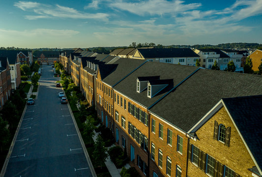Aerial view of a typical American middle class street with brick townhouses and blue sky
