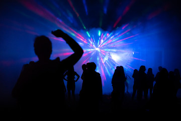 Abstract blurry background, silhouettes of people at open air party