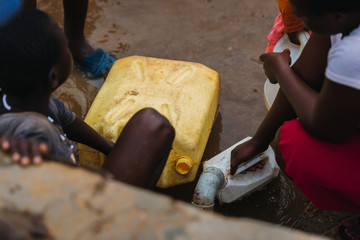 people getting water at a well in Uganda, Africa