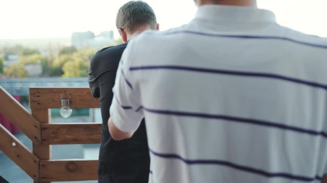 Close up young man gay couple hug have funny in balcon sunlight homosexual men caucasian love male people relationship tenderness together handsome adults marriage sex slow motion