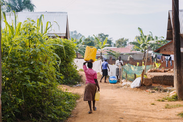 Person carrying water in Uganda, Africa