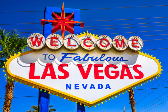 Welcome to Fabulous Las Vegas Nevada, popular landmark Las Vegas Sign on Las Vegas Strip at entrance of the city. Nevada, Unites States. Blue sky.