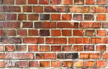 Red aged brick wall texture with sunshine