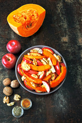 Pumpkin salad with apples and walnuts. Recipe for salad with pumpkin and apples. Vegan nutritious pumpkin salad. Healthy Apple Salad with Pumpkin and Nuts.