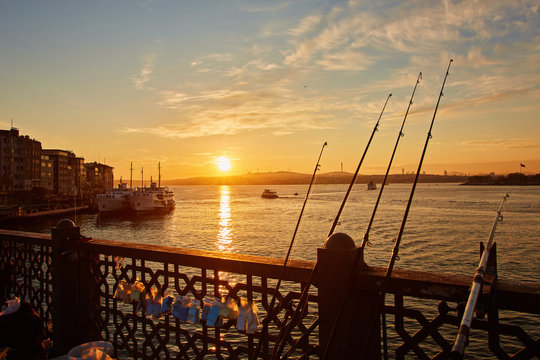 Silhouettes of fishermen fishing on Galata Bridge to relax and enjoy their hobby in Istanbul