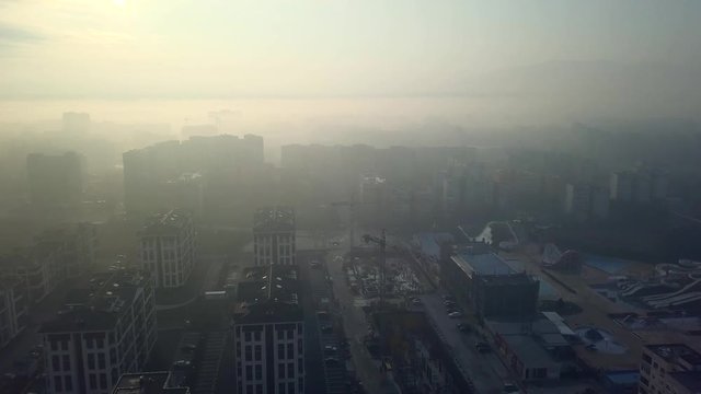Flying over a concrete living apartment area in east Europa with many birds flying around the drone
