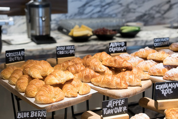 A variety of fresh croissant homemade in luxury hotel breakfast buffet, restaurant interior.