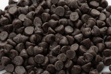 Piles of chocolate chip cookies on the kitchen table waiting to be used in baking chocolate chip cookies in the kitchen