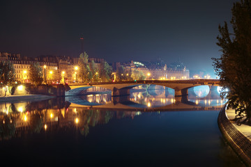 Fototapeta na wymiar Seine, Pont du Carrousel and Orsay Museum at night in Paris, France