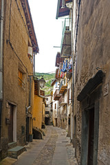 Fototapeta na wymiar Fortified town Tende on Franco-Italian border in French Alps has alpine architecture with the medieval buildings grouped tightly together.