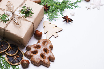 Christmas background with gift box and winter festive decorations on white. New Year celebration traditions concept