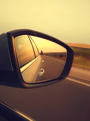 Reflection of sunny road at the car side mirrow. Rear view mirror reflection on sun down © sunlike