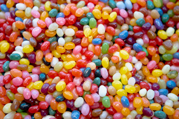 Fototapeta na wymiar Bright, Festive And Colorful Background Or Texture Of Jelly Beans. Cheerful Mix Of Multi-Colored Candies. Children's Holiday Concept.