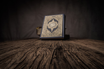 Koran - holy book of Muslims ( public item of all muslims ) on the table , still life - obrazy, fototapety, plakaty