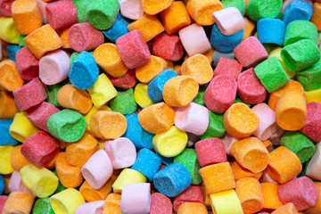 Background Or Texture Of Colorful Mini Marshmallows. Close View Of Colorful Hued Miniature Green, Pink, Yellow, Blue And Orange Candies. Cheerful Mix Of Multi-colored Sweets. Children Holiday Concept.