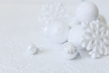 Fototapeta na wymiar Christmas or new year composition. Christmas decorations in silver and white colors with balls and snowflake