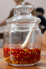 Fish sauce with chili in glass bottle isolated on white background