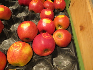 Red apples in a box with hearts and smiley faces