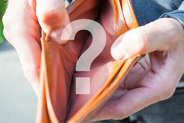 A man holds in his hands and shows a wallet without money, question mark image
