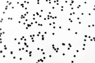 Spiders confetti on the white background. Halloween party concept. Flat-lay, top view.