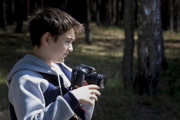 Portrait of a young photographer shooting a landscape