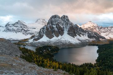 Cerulean lake is glowing orange at sunset in Assiniboine Provincial Park