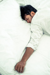 Young man sleep in bed in the bedroom.