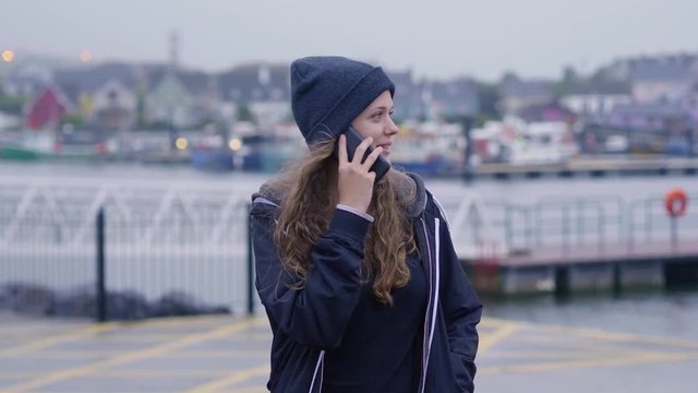 Happy girl talks to her friend on the phone