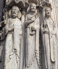 Fototapeta na wymiar Statues of Catholic Saints at Cathedrale Notre Dame de Chartres, a medieval old Catholic cathedral in Chartres, France