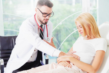 Male Doctor and Female Patient in Hospital Office