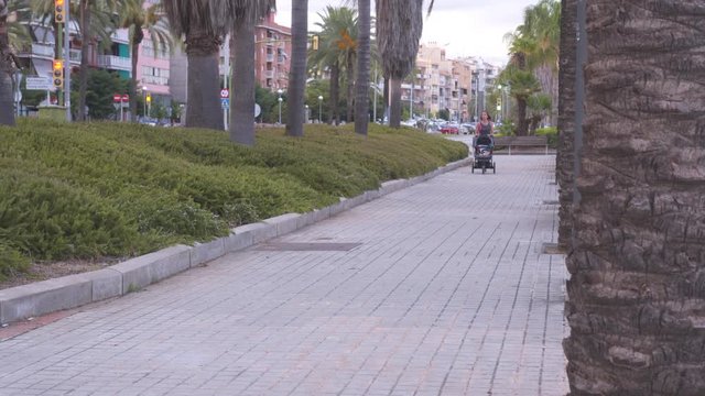 Active mother jogging with baby in pram