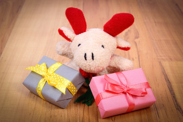 Fototapeta premium Plush reindeer with gifts for Christmas or other celebration