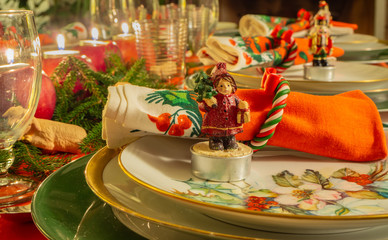Christmas table set with decorated napkin and statuette