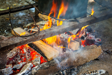 A cast iron pot is used for traditional cooking on an open fire in Georgia