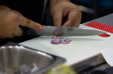 chopping garlic on wooden board for cooking