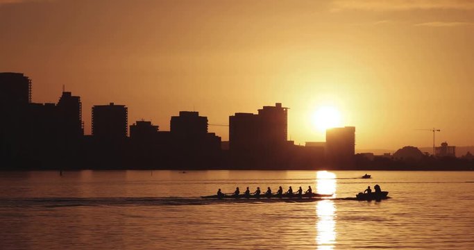 People rowing in the early hours during golden hour. Location in Perth, Western Australia.