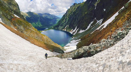 Morskie Oko. High Tatras, Poland, May 27, 2018. Beautiful landscape of snowy mountain tops and the lake between them. © volff